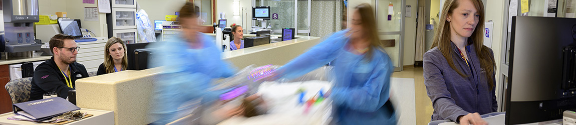 Healthcare workers moving a patient on a bed